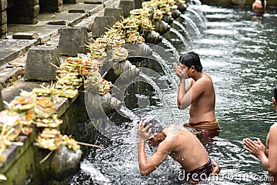 Male balinese having a ritual bath at Holy Spring Water Editorial Stock Photo