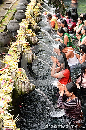 Devotees at ritual purification. Tirta Empul. Tampaksiring. Gianyar regency. Bali. Indonesia Editorial Stock Photo