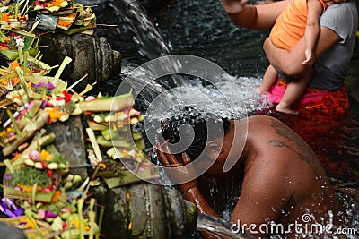The ritual purifying bath in the temple pond. Tirta Empul. Tampaksiring. Gianyar regency. Bali. Indonesia Editorial Stock Photo