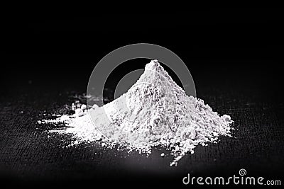 Titanium dioxide TiO2 powder for cosmetics, isolated black background Stock Photo