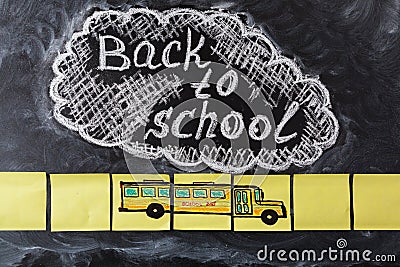 Title Back to school written by chalk on the chalkboard and the school bus drawn on pieces of paper Stock Photo