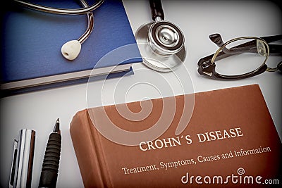 Titled book Crohn`s Disease along with medical equipment Stock Photo