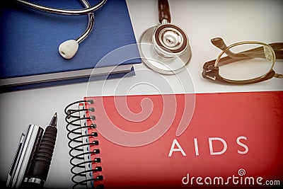 Titled red book aids along with medical equipment Stock Photo