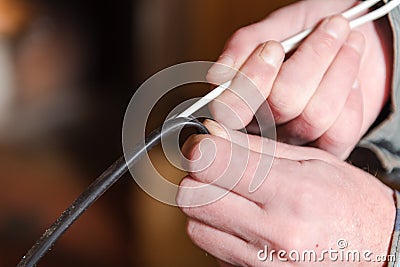 to bare the wire. remove the braid from the wire. clean the wire. electrical work Stock Photo