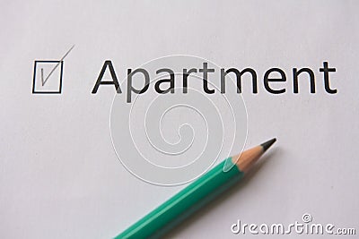 To buy an apartment. word APARTMENT is written on white paper with tick and gray pencil. Stock Photo