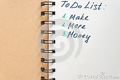 To do list - make more monTo do list - make more money written text on note pad. Close upe written text on note pad Stock Photo