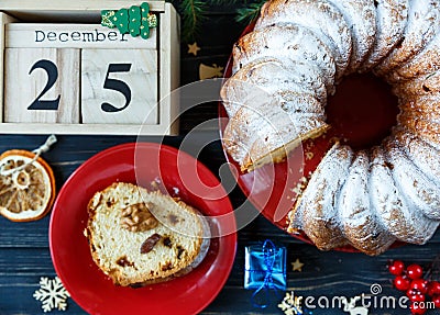 To do list on wooden pad with red cup of coffee, piece of cake and branches of fir tree, wooden calendar on a table. Stock Photo