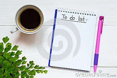 To do list written in the notebook. Notebook with to do list on wooden desk with cup of coffee Stock Photo