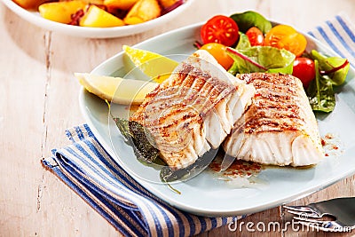 To portions of fresh grilled pollock Stock Photo