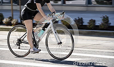 Woman cycling to lose weight and keep fit Stock Photo