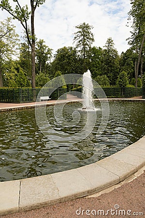 Petergof, Russia, July 2019. The fountain in the center of the green labyrinth in the park. Editorial Stock Photo