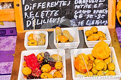 Sampling of a variety of olives and red pepper with different olive oils Stock Photo