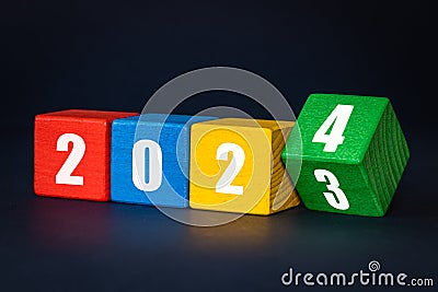 2023 to 2024, White numbers with date on colored blocks, Merry Christmas and Happy New Year, Navy blue background, Concept, new Stock Photo