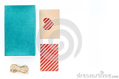 To wrap gift. Box, kraft paper, envelope, greeting card, on white background top view copyspace Stock Photo