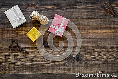 To wrap gift. Boxes, thin cord, sciccors on wooden background top view copyspace Stock Photo