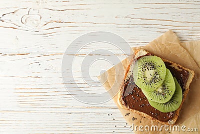 Toast with choco cream and kiwi on wooden background Stock Photo