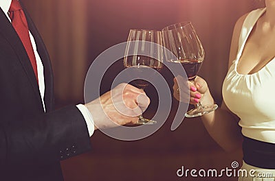 Toast of couple clink glasses with red wine Stock Photo