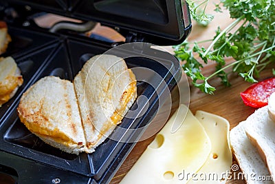 Toast heart shape with toaster sandwich maker love valentines breakfast concept Stock Photo