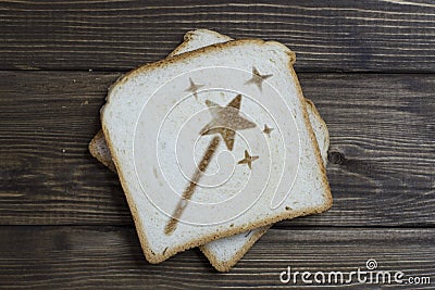 Toast with the sign of the magic wand on dark wood Stock Photo