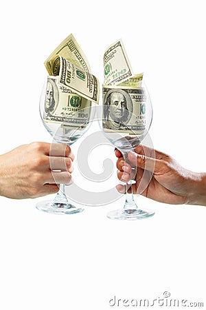 Toast using glass filled with dollar bills Stock Photo