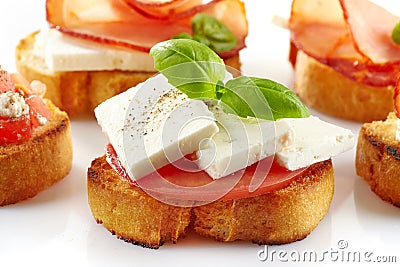 Toasted bread with fresh goat cheese and tomato Stock Photo