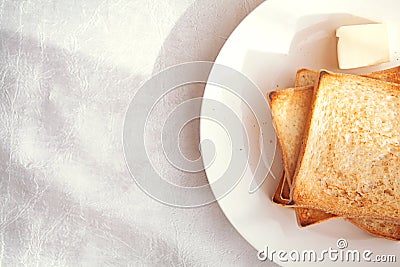 Toasted bread slices with butter pat for breakfast Stock Photo