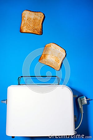 Toaster with slices of bread on a blue background. top view vertical photo. Flat lay Stock Photo