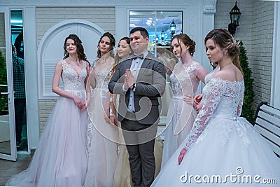 A toastmaster posing for the camera among the bride models Editorial Stock Photo