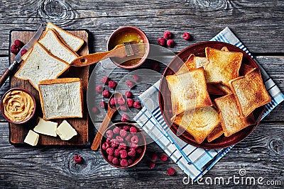 Toasts, butter, peanut butter, berries, top view Stock Photo