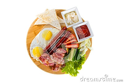 Toasts, fried eggs, sausages, meat and vegetables Stock Photo