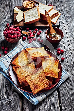 Toasts, butter, berries on a table, top view Stock Photo