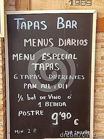 Todayâ€™s menu in Spanish on blackboard outside in the street for a Tapas bar Editorial Stock Photo