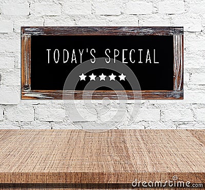 Today's special on vintage chalk board over cement wall and empt Stock Photo