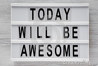 `Today will be awesome` words on modern board over white wooden background, top view. Overhead, flat lay, from above Stock Photo