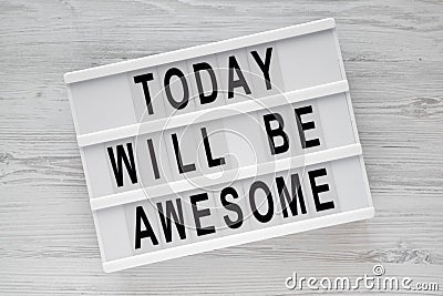 `Today will be awesome` words on modern board over white wooden surface, overhead view. Stock Photo