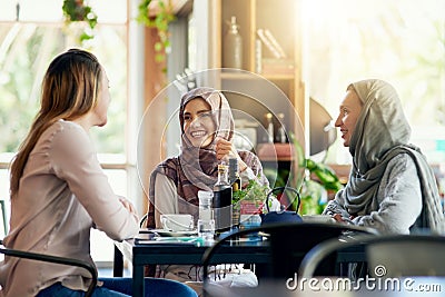 On todays menu Good friends and good times. a group of women chatting over coffee in a cafe. Stock Photo