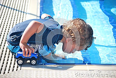 Toddler boy blowing bubbles in a pool Stock Photo