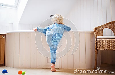 Toddler boy in a dangerous situation in the bathroom. Stock Photo