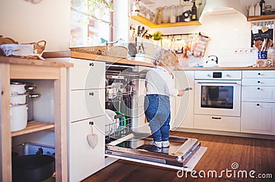 Toddler boy in dangerous situation at home. Child safety concept. Stock Photo