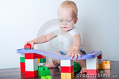 Toddler boy plays with constructor, cars, blocks close-up. Educational toys for preschool children Stock Photo