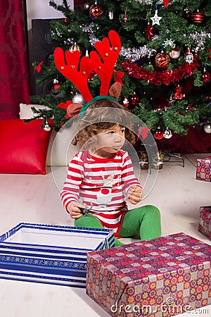 Toddler boy with reindeer ears looking away Stock Photo