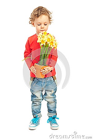 Toddler boy smelling flowers Stock Photo