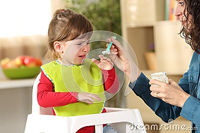 Toddler crying at lunch time Stock Photo