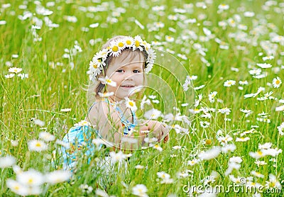 Toddler girl on the daisy meadow Stock Photo