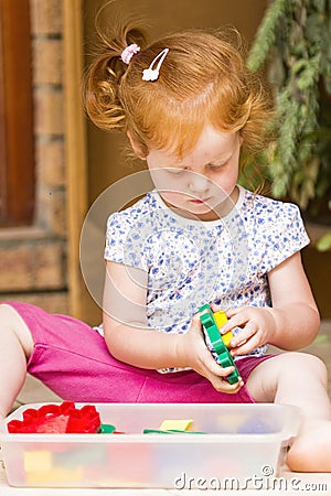 Toddler girl playing toys Stock Photo