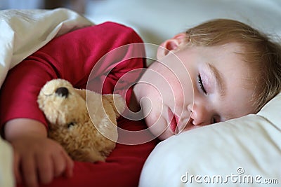 Toddler girl sleeping in bed Stock Photo