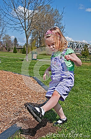 Toddler Girl is Stomping Dirt Stock Photo