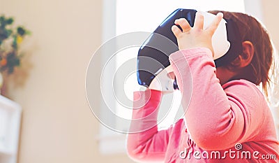 Toddler girl using a virtual reality headset Stock Photo