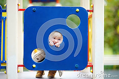 Toddler having fun on playground Stock Photo