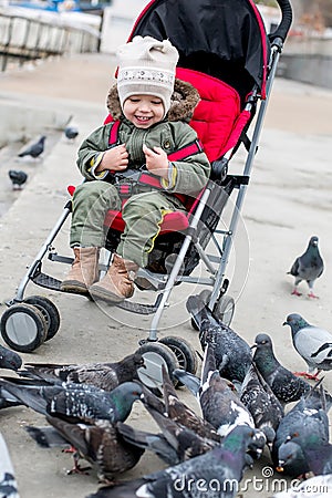 Toddler laughing baby in the stroller Stock Photo